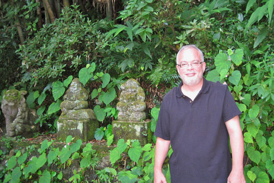 Mark Schumacher poses in front of century-old statues in the garden of his home in Kamakura, Kanagawa Prefecture. 