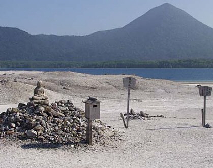 Jizo surrounded by prayer stone at Sainokawara, Osorezan. Photo courtesy Ellen Schattschneider