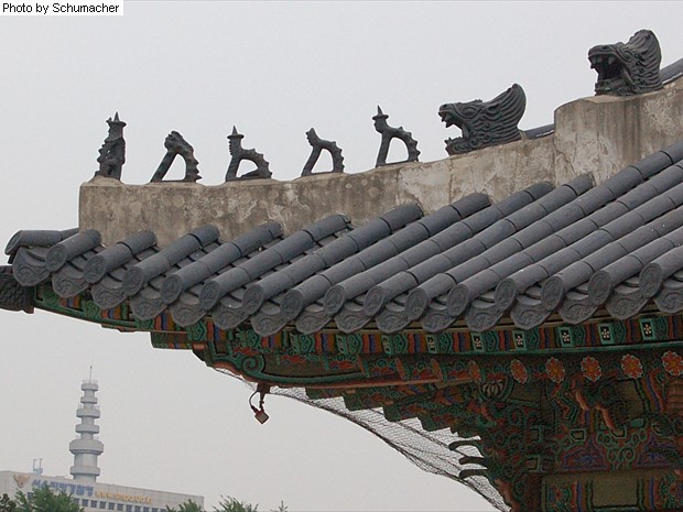 Roof tiles at Gyeongbokgung Palace, Seoul, Korea. The protective rooftop effigies come in various configurations, including groups of three, five, six, seven, and eleven, and meant to protect against fire.