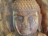 Wood carving of Buddha showing a second face emerging from main head. Probably suggests the 'Buddha hidden within each of us' or our true nature. Statue found in small shop outside Donghaksa Temple.