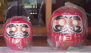 Daruma tumbler dolls, still in their protective plastic wrapping